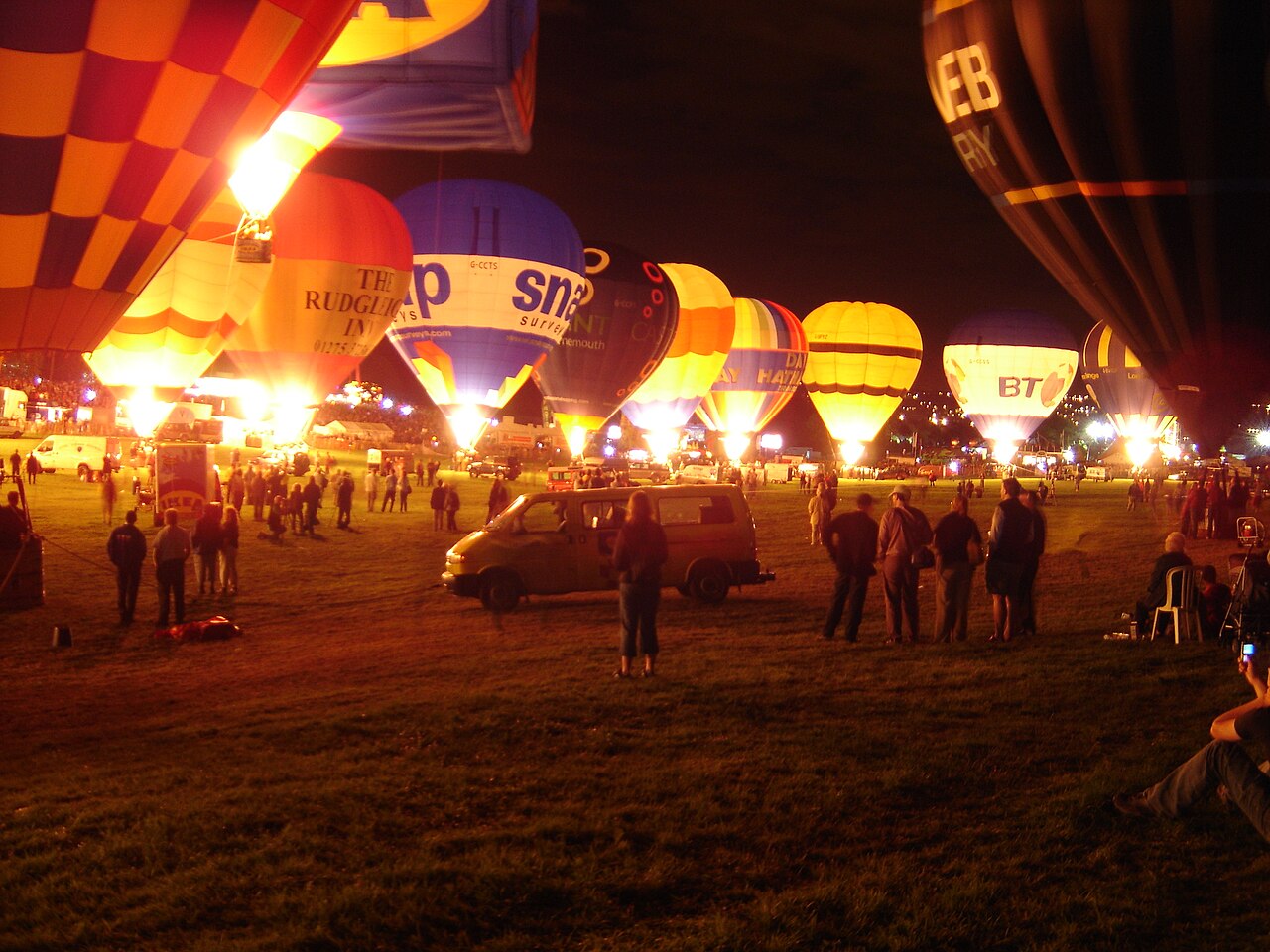 Hot air balloons glowing at night at a previous Bristol Balloon Fiesta